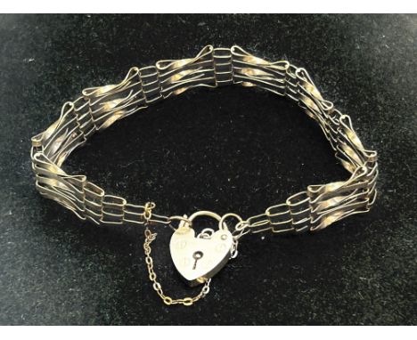 9ct gold gate bracelet with heart shaped locket and safety chain, weight 8.6grams