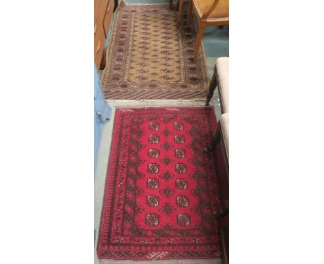 A red ground Turkeman rug, 115cm x 82cm and a light ground Bokhara rug, 156cm x 98cm (2) Condition Report: Available upon req