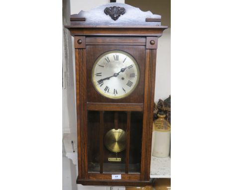 A stained wood wall clock with Roman numerals Condition Report: Available upon request