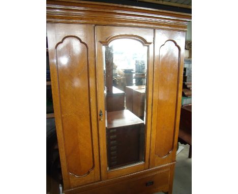 Edwardian light oak wardrobe enclosed by single bevelled edge mirror door with single drawer to the base (width 137cm) 