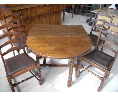 Oak drop leaf gate leg table on turned supports and a set of four ladder back dining chairs with drop-in seats 