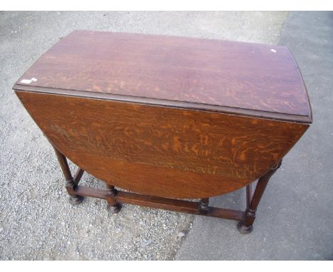 Oak drop leaf gate leg table on carved supports 