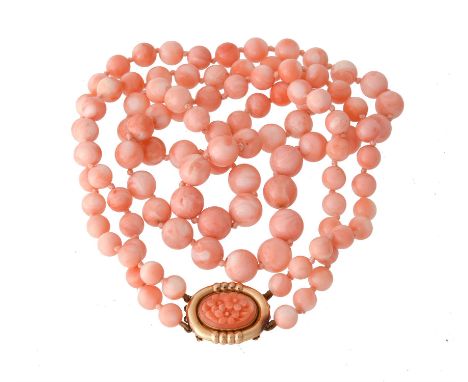 Y A two row coral bead necklace, the graduated coral beads measuring 7mm to 11mm, to a floral carved coral panel clasp with a