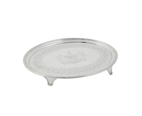 A George III silver oval salver by William Bennett, London 1802, with a reeded border, engraved with an armorial, on four bra