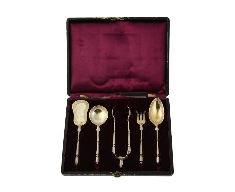 A French silver gilt serving set by Henin & Cie, Minerva .925 standard, comprising, a pair of sugar tongs, a pickle fork and 