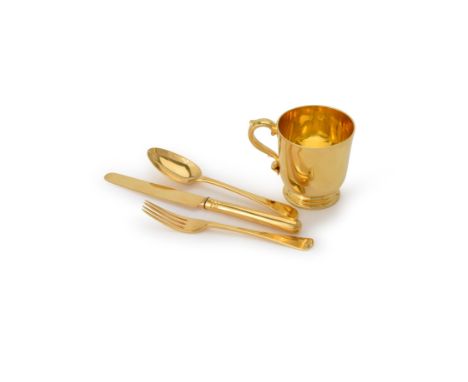 A Victorian silver gilt four piece christening set, London 1871, the plain tapered mug with a tongue-capped capped S-scroll h