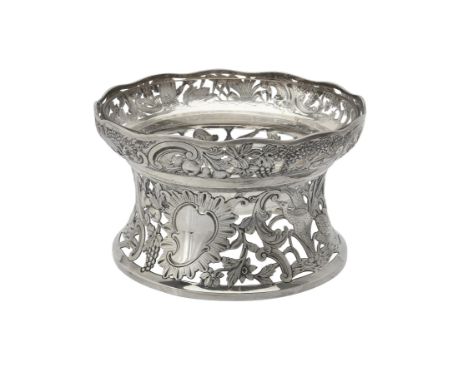 An Edwardian silver dish ring by Carrington & Co., London 1908, with a shaped border, chased and pierced with animals, fruit,