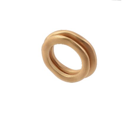 A gold coloured double hoop ring by Pomellato, the softly undulating brushed gold hoops joined at a point, signed Pomellato a