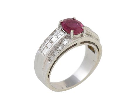 A ruby and diamond ring, the central ruby claw set above channel set step cut diamonds, to brilliant cut diamonds set borders