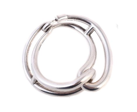 A silver coloured hinged bangle by Hermès, with shaped tapered curved interlocking panels, stamped Hermès Au925s with French 