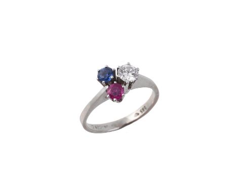 A diamond, sapphire and ruby three stone cluster ring, the brilliant cut diamond estimated to weigh 0.22 carats claw set abov