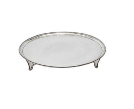 A George III silver circular salver by John Crouch I & Thomas Hannam, London 1782, with a beaded border and on four beaded br