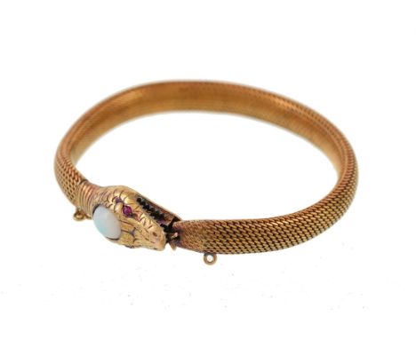 A 1920s 15 carat gold serpent bracelet, the naturalistic head clasp set with a central oval cabochon opal, with ruby eyes, st