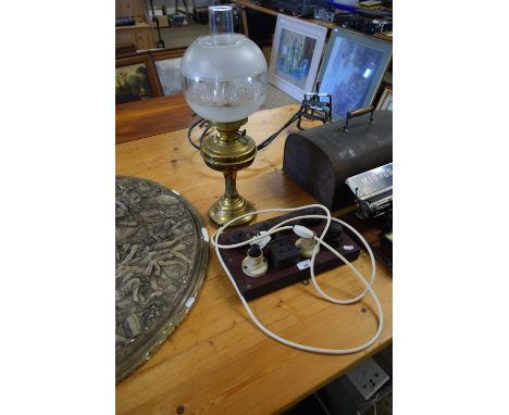 BRASS BASED OIL LAMP WITH LATER ELECTRICAL CONVERSION, TOGETHER WITH A BOARD OF VINTAGE ELECTRICAL FITTINGS (2)
