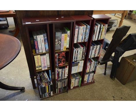 FOUR SMALL SHELF UNITS CONTAINING RANGE OF VARIOUS DVDS, VIDEOS AND CDS