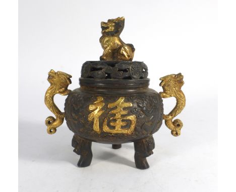A Chinese brown patinated and gilt highlighted bronzed koro of traditional form, having a foo dog finial and a pair of dragon
