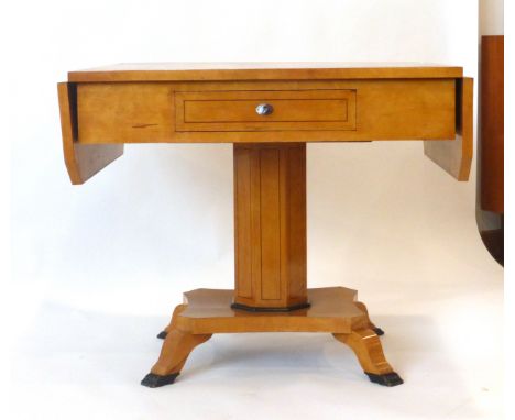 An Empire-type birch and strung sofa table with drop-ends on a column and platform base with claw feet, max. w. 135 cm