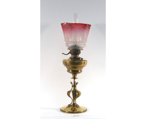 A late 19th century brass oil lamp with a graduated cranberry and etched glass shade, h. 62 cm CONDITION REPORT: No obvious c