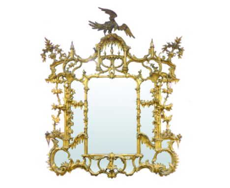 A mid-19th century carved giltwood and gesso wall mirror, in the Chinese Chippendale taste, the frame surmounted by an eagle 