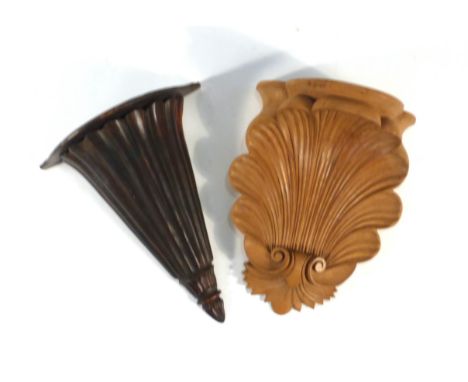 A carved pine wall bracket of scrolled foliate form, 45 cm, together with a similar mahogany bracket