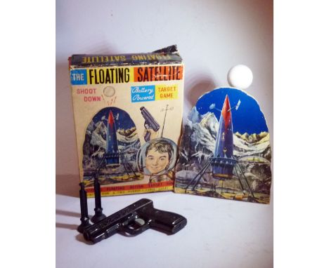 FLOATING SATELLITE TARGET GAME - HORIKAWA - JAPAN. 1960 Tin battery operated shooting game. A battery-powered fan behind the 