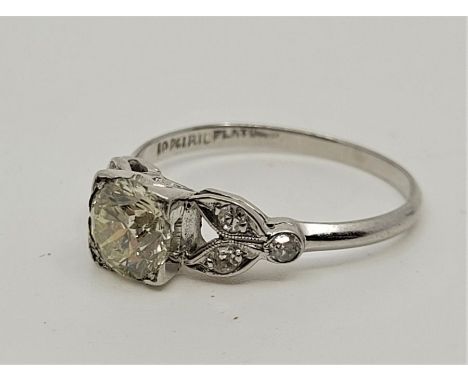 A platinum and diamond ring, set central round brilliant cut diamond to centre&nbsp;(EDW 0.85 carats) and three round cut dia