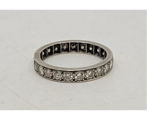 A precious white metal diamond eternity ring, set twenty-three round brilliant cut diamonds, (ETDW 1.2 carats, white metal as