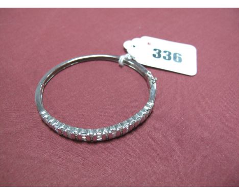 A Modern 18ct White Gold Diamond Set Bangle, bar set to the front with three rows of alternate brilliant and baguette-cut sto