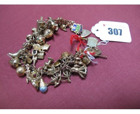 A 9ct Gold Fancy Link Bracelet, to heart shape padlock clasp (safety chain broken) suspending numerous novelty charm pendants