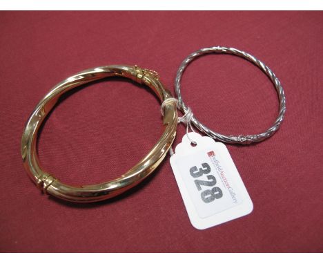 A Modern Bangle, of twisted design, stamped "375", together with a smaller example.