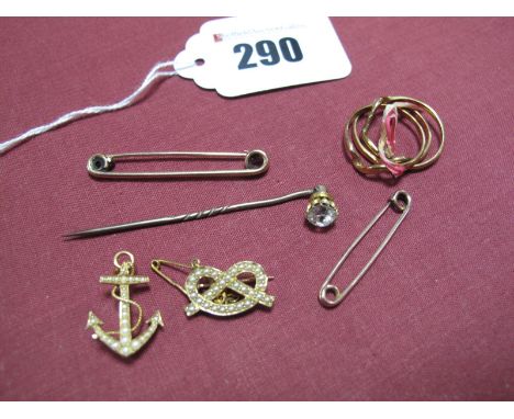 A Seed Pearl Set Anchor Brooch, stamped "15ct, together with a seed pearl knot brooch, two stock pins, a stick pin and a puzz