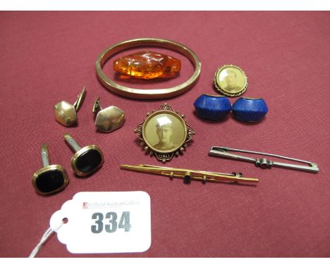 A Continental Bangle, hinged to snap clasp stamped "333", two early XX Century locket brooches, containing photographs of Ger