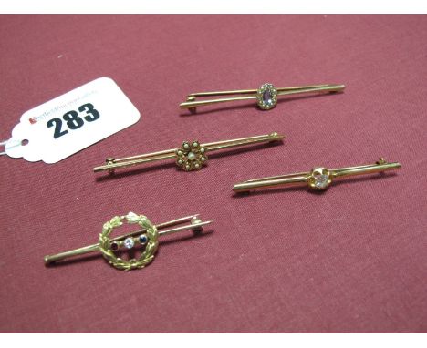 A Diamond Set Bar Brooch, applied to the bar with laurel wreath circlet, collet set to the centre with a ruby, diamond and sa