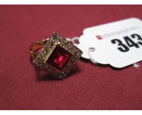 A Modern Synthetic Ruby and Diamond Cluster Ring, the central square synthetic ruby collet set, within millegrain border of b
