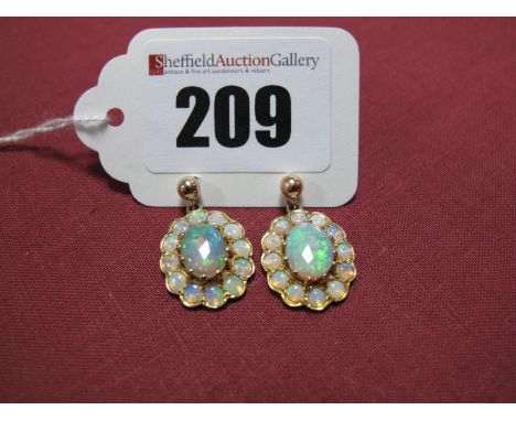 A Pair of Modern Opal Cluster Earpendants, each composed of central oval cabochon opal, claw set within shaped border of circ