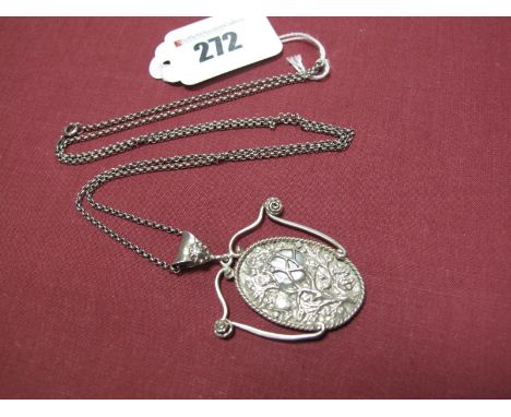 An Art Nouveau Pendant, the oval panel with mother of pearl detail, between scrolling shoulders and wide bale, on chain.