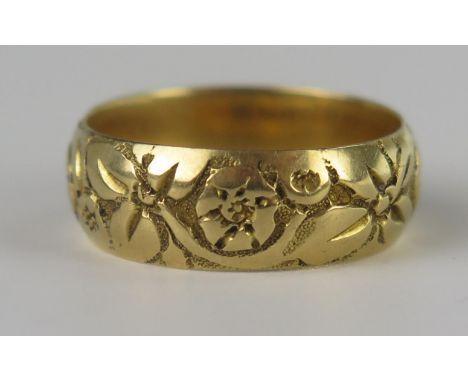 A Victorian 18ct Gold Floral Decorated Wedding Band, 17mm wide, size R, 7.4g, London 1859, maker W.W.LD 