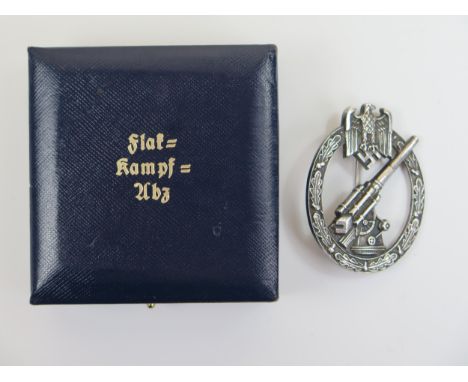 A Nazi German Army Flak Badge, maker mark A.G.M.U.K. GABLONZ andn in original box 