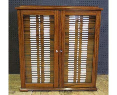 A Victorian Rosewood Glazed Slide Cabinet with seventy-two numbered bone handled and inlayed draws and another two larger dra