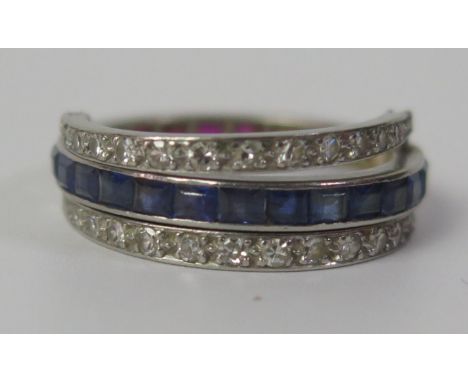 A Sapphire, Ruby and Diamond Eternity Ring with flip diamond arms and in a precious white metal setting, size M, 5.3g. One hi