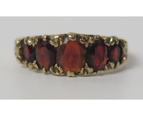 A 9ct Gold and Garnet Five Stone Ring, size R.5, 3.7g 