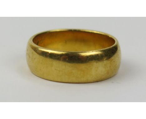 An Unassayed High Carat Gold Wedding Band, 6.3mm wide, size K.25, 7.9g 