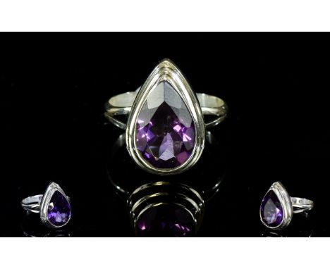 Ladies Silver And Amethyst Dress Ring Faceted teardrop/pear shaped Amethyst set in raised, stepped silver surround with fine 