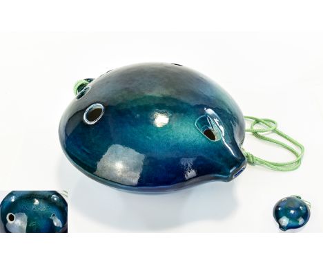 A Ceramic Ocarina Handheld spherical flute instrument in glazed blue ceramic, boxed and complete with instructions