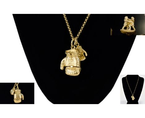 A Good Quality and Well Made Pair of 9ct Gold Charms In The Form of Articulated Boxing Gloves, Attached to a 9ct Gold Chain. 