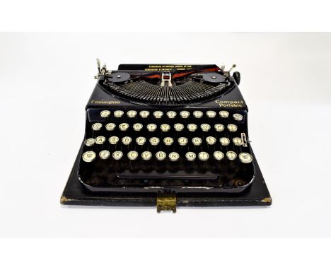A Vintage Remington Comparct Portable Typwriter. Housed in original black leather bound carry case. Finished in traditional b