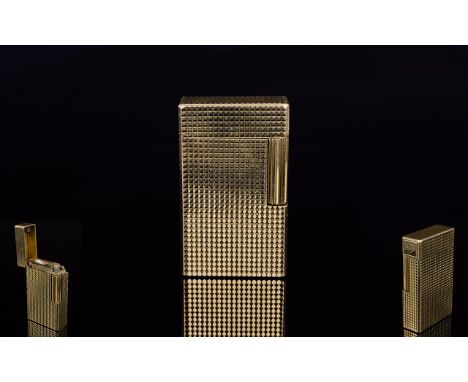 A 1970'S Gas Cigarette Lighter By S T Dupont A slim gold tone lighter with textured finish in good working order. Marked to b
