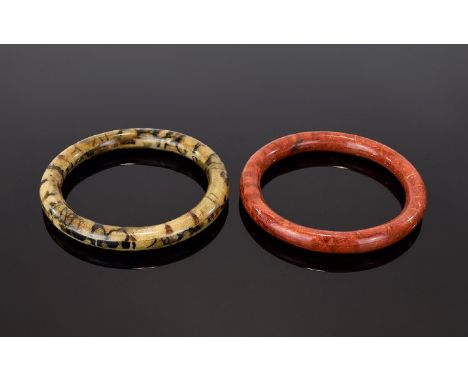 A Pair Of Vintage Agate Effect Bangles Two in total, the first in brick red tone with striated detail. The second in earth to