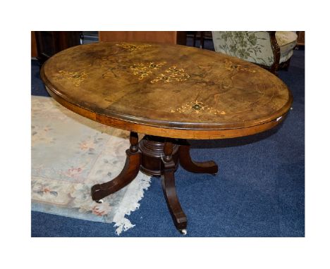 Walnut Tile Top Table, Oval Top with Inlay, Quadrafoil Base on Ceramic Castors. 46 Inches wide & 27 Inches High. 