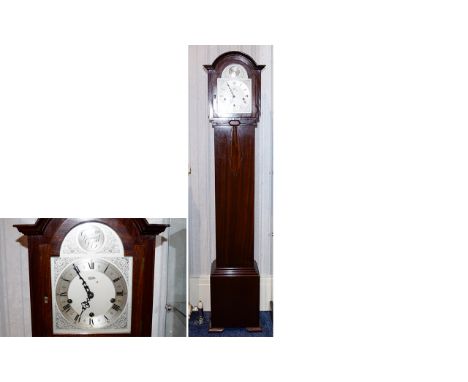 A 1930's Granddaughter Clock Dark wood case with applied wood fan detail to central panel. The brushed silver tone face with 